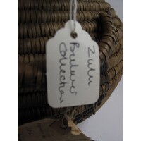 Oval paper label tied to object