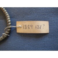Rectangular brown paper label tied to object (01)