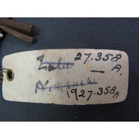 Rectangular parchment label tied to object (view 1)