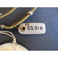Small oval parchment label tied to object
